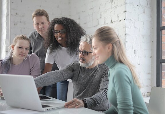 cheerful-diverse-colleagues-working-on-laptop-in-office-3860813__1_.jpg  